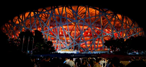 The illuminated Bird’s Nest stadium at night