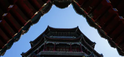 A traditional tower framed by tiled eaves