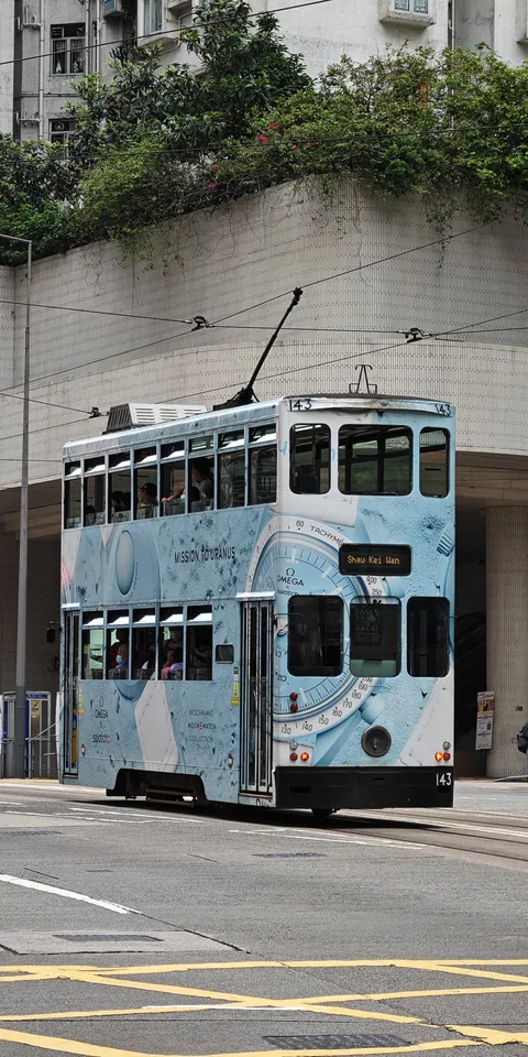 A blue tram on a Hong Kong street