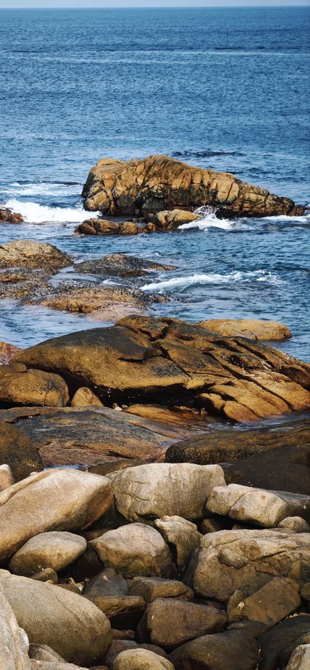 Rounded rocks along the shoreline