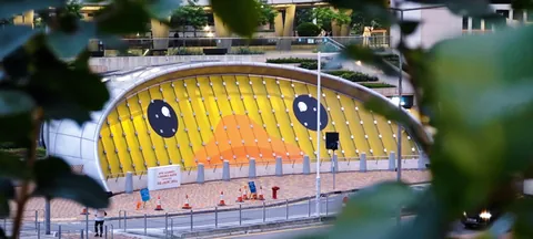 A yellow duck reflected in a building facade