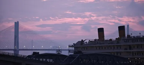 A city skyline under a pastel sunset