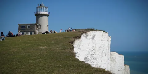 A lighthouse above a white cliff