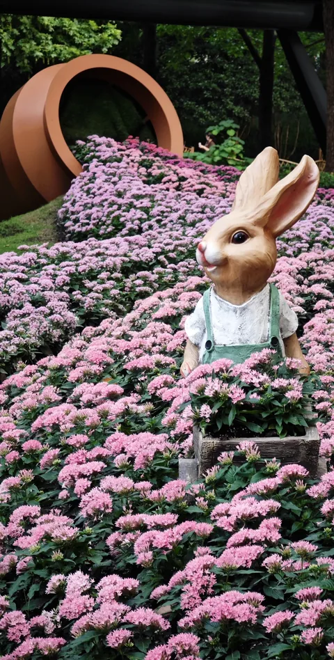 A rabbit sculpture in a flower display