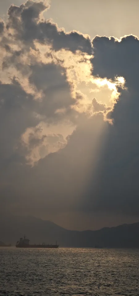 Sunlight breaking through clouds over the sea