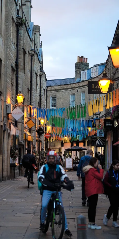 A crowded street beneath historic buildings