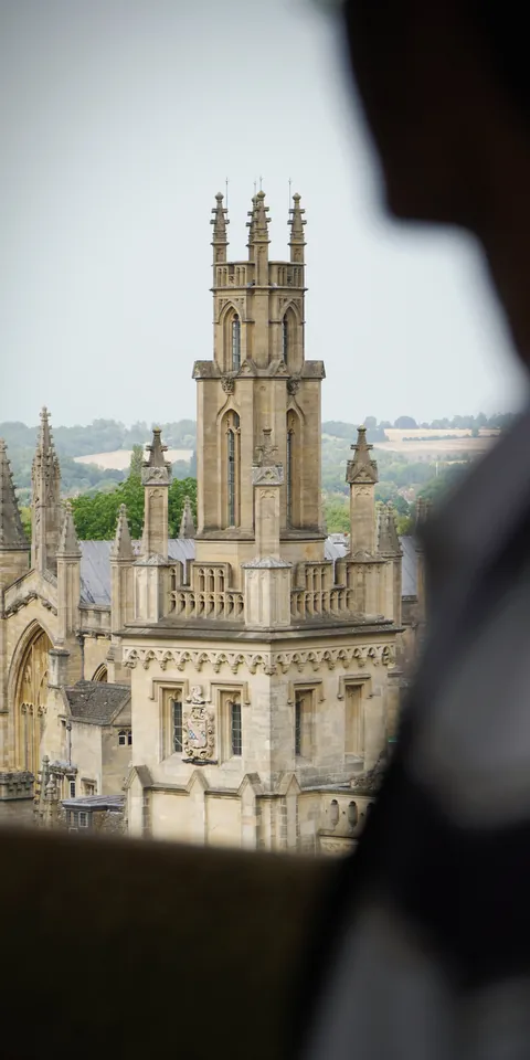 A historic tower framed by a window