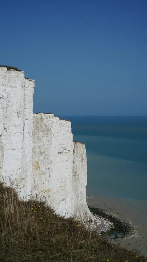 A white cliff against a deep blue sky